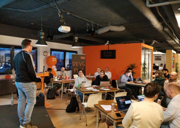 Meetup host on podium doing introduction talk of the workshop